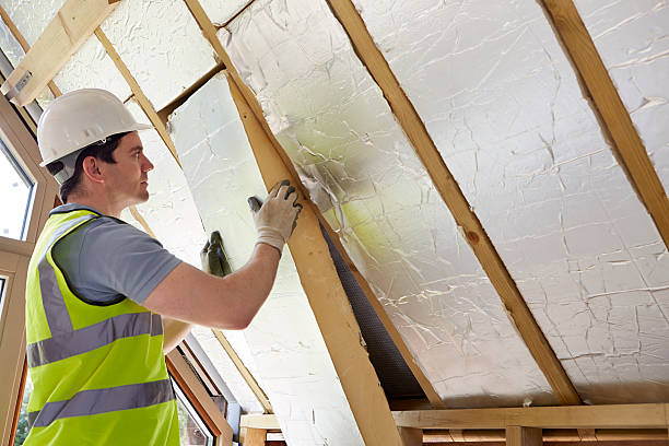 builder fitting insulation into roof of new home builder fitting insulation into roof of new home